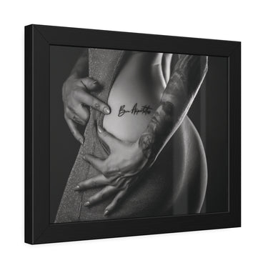 Angled view of 14x11 sensual nude wall art showcasing a woman's exposed waist and curving buttocks, with tattooed arms framing her body. One hand rests near her abdomen while the other spreads across her hip, creating expressive lines against a softly illuminated monochrome background.